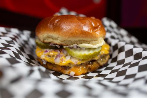 Burger Burger with melted cheese and pickles.